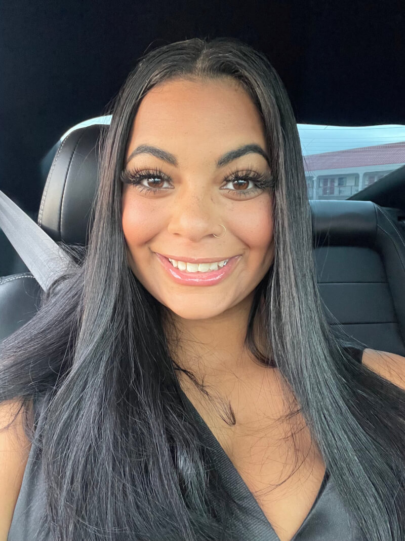 portrait of smiling woman in car seat